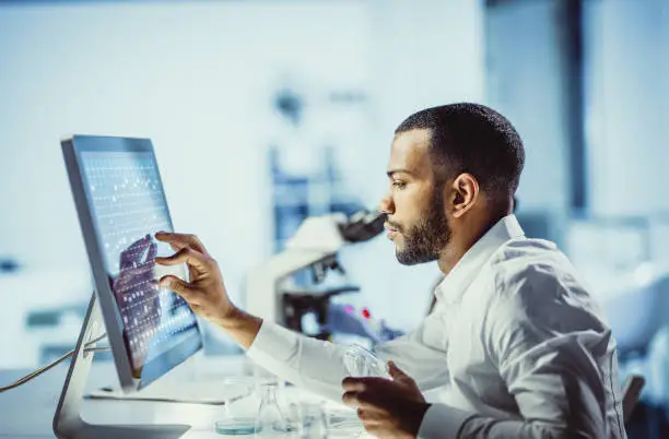 Scientists Working in The Laboratory, Using Touch Screen