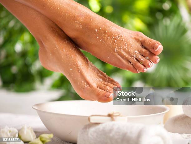 Foot Spa On A Tropical Green Leaves Background Stock Photo - Download Image Now - Foot, Pedicure, Exfoliation