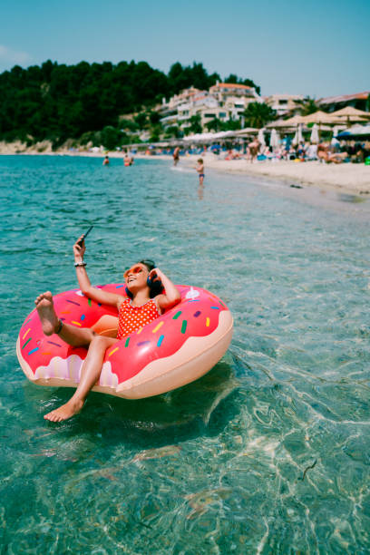 Kid floating on water in donut life belt
