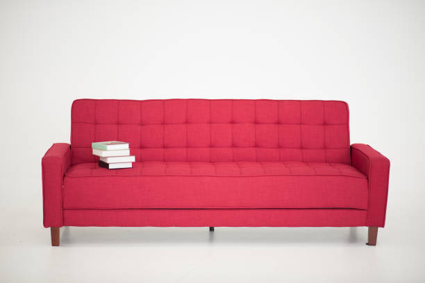 istock some book stay on a red sofa, on white background 1131585526