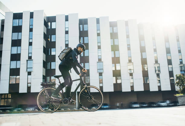 istock Male courier with bicycle delivering packages in city. Copy space. 1131585658