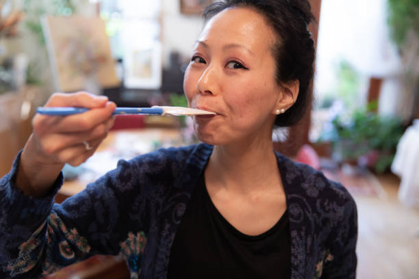 istock Beautiful woman tasting dough 1131587000