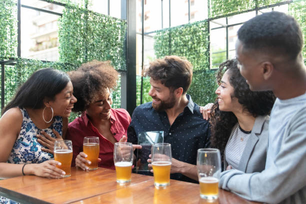 istock Man showing his friends a prize he won while all are happy and talking 1131587143