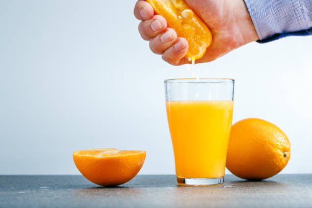 istock Man making healthy organic orange juice 1131587199