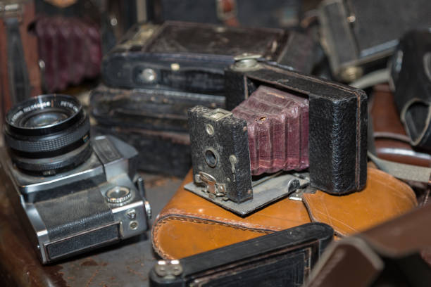 istock Antique Folding Camera with Bellows in a Pile of Old Cameras 1131587475
