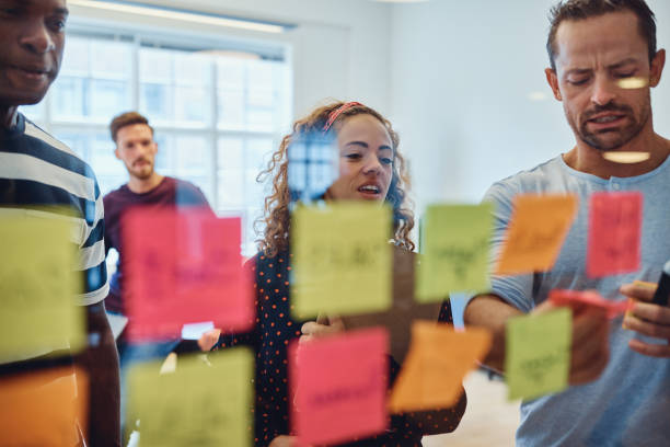 istock Diverse designers brainstorming with notes on a glass wall 1131588728