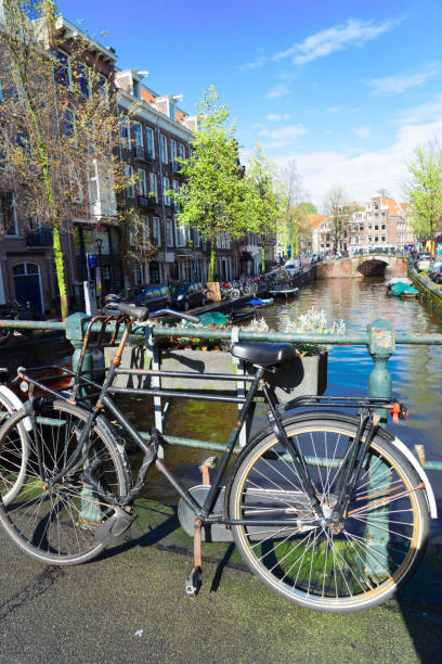 istock Old bicycle next to canal of Amsterdam 1131588798