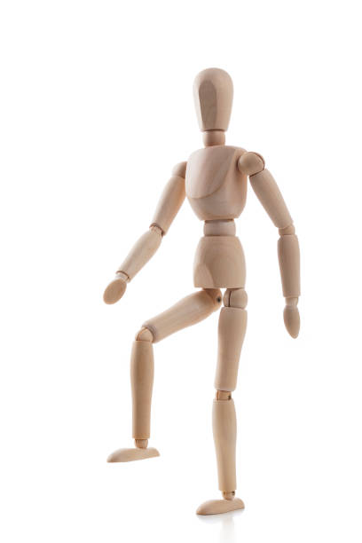 istock Wooden mannequin stepping isolated on white background 1131590047