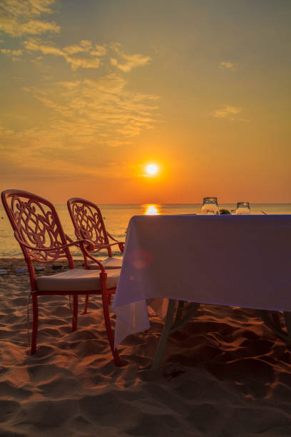 istock Restaurant on the Beach. Romantic Beach Dinner during Sunset. Vertical. 1131590781