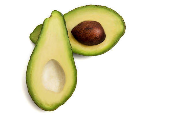 istock green avocado cut in half lying on a white background 1131590841