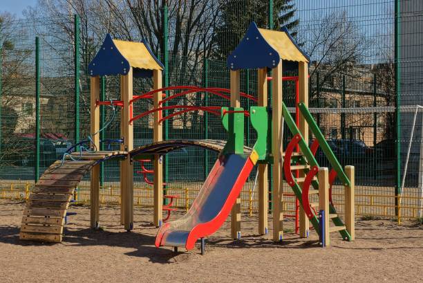 istock playground with colored slide and buildings outside 1131591517