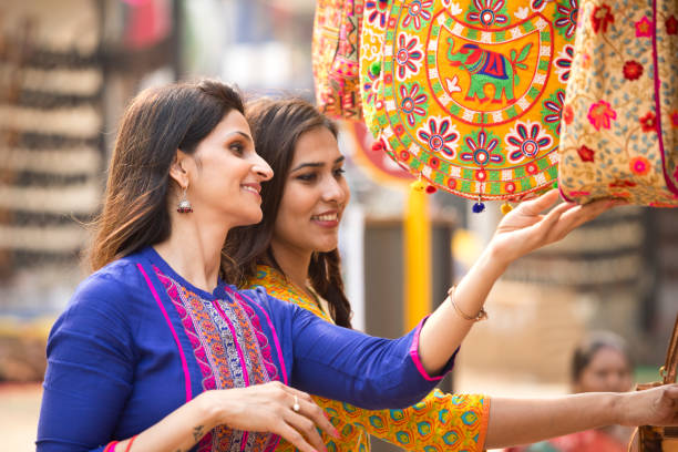 Women shopping for bag at market Happy women shopping for bag at street market india indian culture market clothing stock pictures, royalty-free photos & images