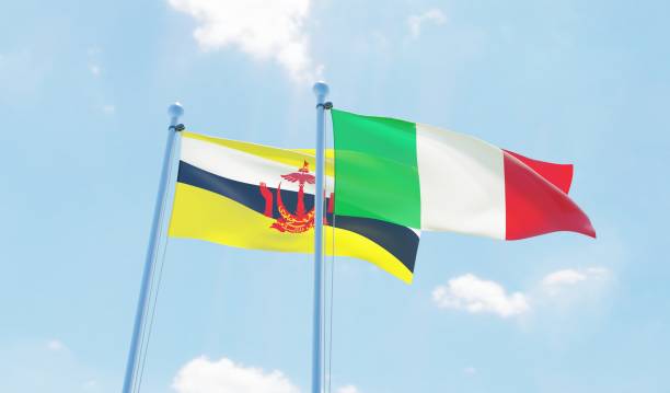 istock Italy and Brunei, two flags waving against blue sky 1131594518