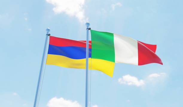 istock Italy and Armenia, two flags waving against blue sky 1131594687