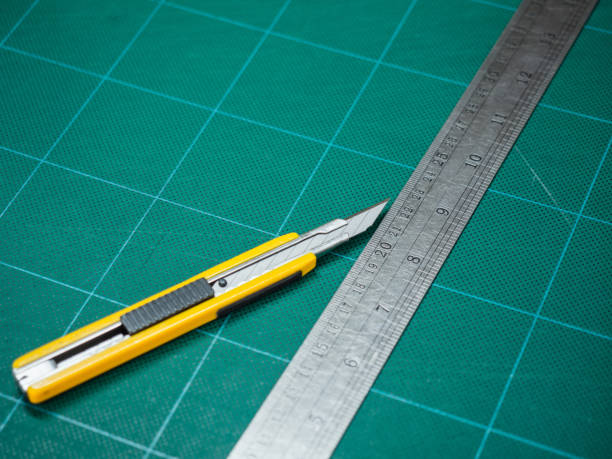 istock Cutter and  iron ruler isolated on a cutting mat 1131594731