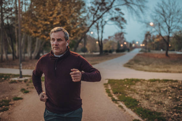 istock Senior runner listening to music 1131596377