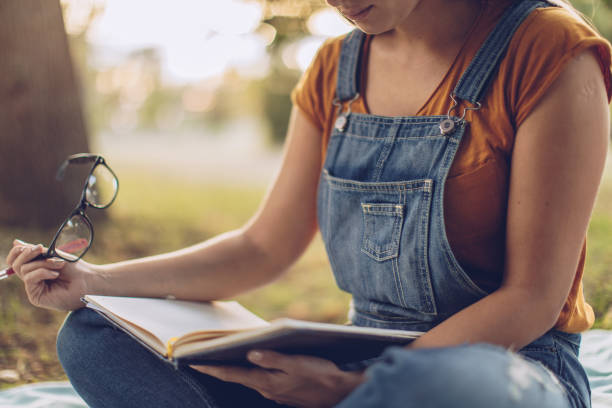istock Woman studying in public park 1131596469