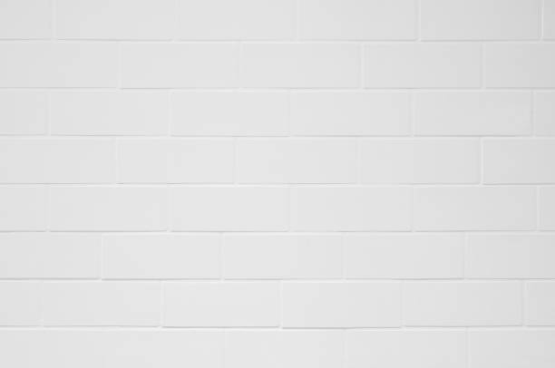 istock Closeup white brick wall tile texture background,clean and  light grey wall interior, rural room,grunge. Wall design modern horizontal lines pattern for interior or architecture. 1131597815