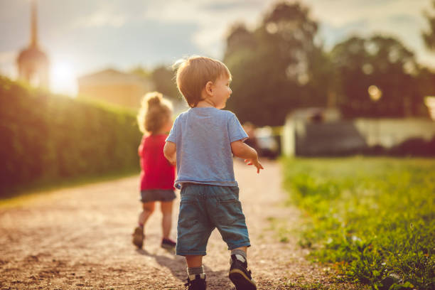 istock Cute boy and girl outdoors playing outdoors in summer sunset 1131598232