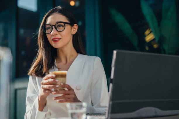 istock Elegant businesswoman drinking coffee 1131598508