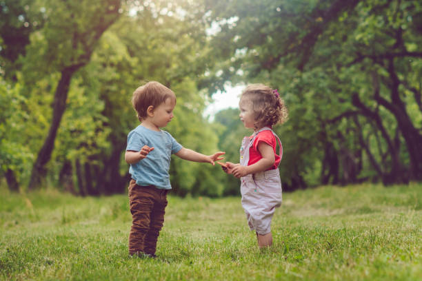 istock Two happy children playing in summer park 1131599286