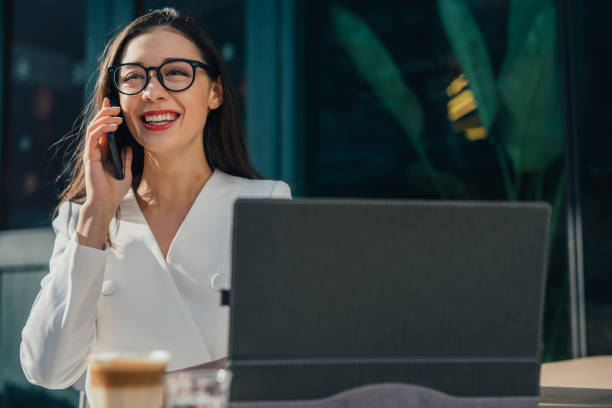 istock Young businesswoman talking on phone and smiling 1131600736