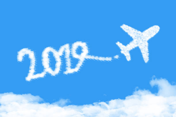 istock Airplane shape clouds 2019 route. Happy new year concept 1131601629