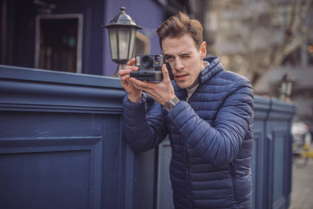 istock Photographer taking photos with instant camera 1131602245