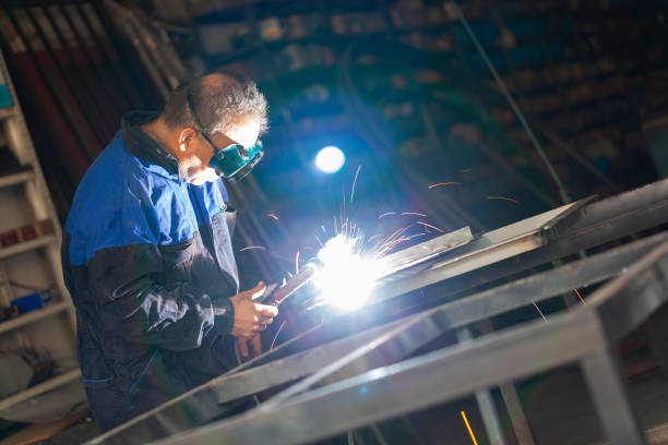 Arc welder with welding mask and sparks Arc welder with welding mask and sparks welder engineering construction bright stock pictures, royalty-free photos & images