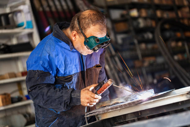 Arc welder with welding mask and sparks Arc welder with welding mask and sparks welder engineering construction bright stock pictures, royalty-free photos & images