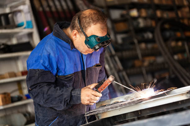 istock Arc welder with welding mask and sparks 1131606853
