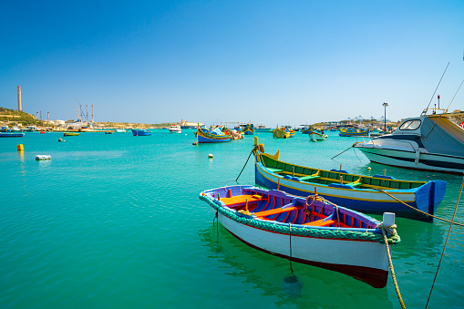 May 20, 2018. Marsaxlokk, Malta. Beautiful view on the traditional eyed colorful boats Luzzu in the Harbor of Mediterranean fishing village Marsaxlokk, Malta.