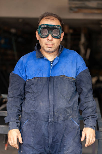 Manual worker portrait with welding mask Manual worker portrait with welding mask welder engineering construction bright stock pictures, royalty-free photos & images