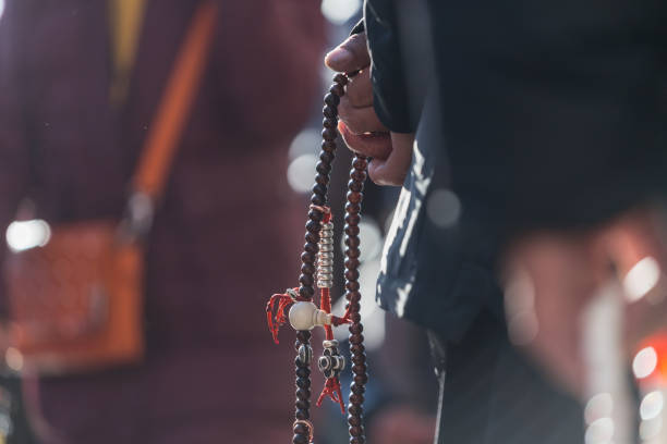 istock Old Tibetan Holding Prayer Beads 1131609033