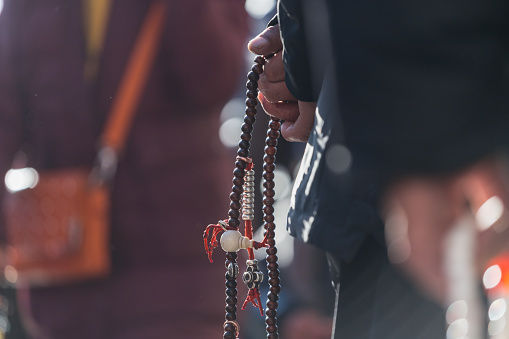 Old Tibetan Holding Prayer Beads