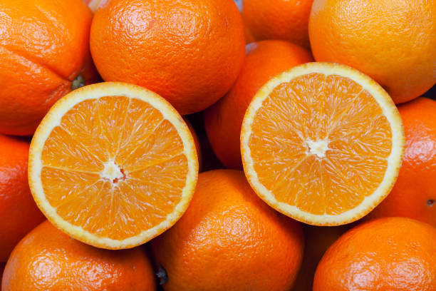 istock A pile of oranges with a cut in half on top 1131609099