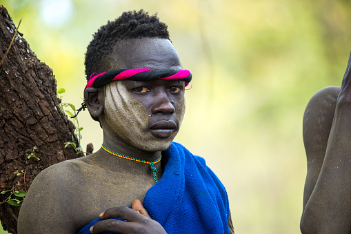 A young Mursi man with his Donga fighting stick, a traditional tournament that occurs once a year in the Omo Valley.