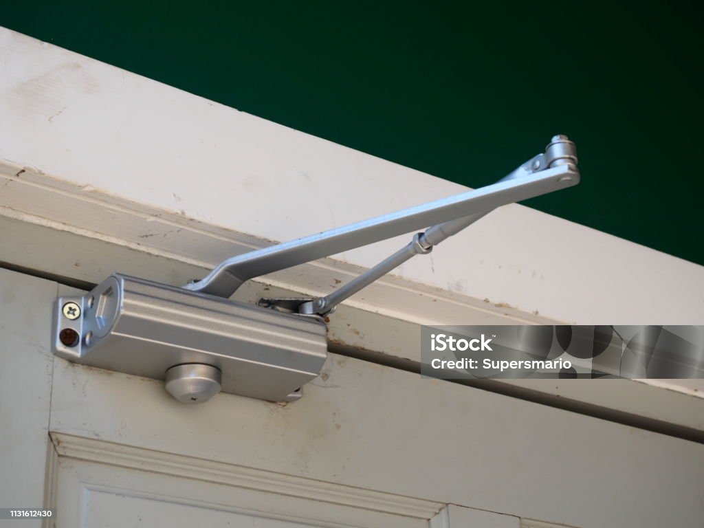 Door closer or shock absorber installation Door, Magnifying Glass, Automatic, Accessibility, Architecture Door Stock Photo