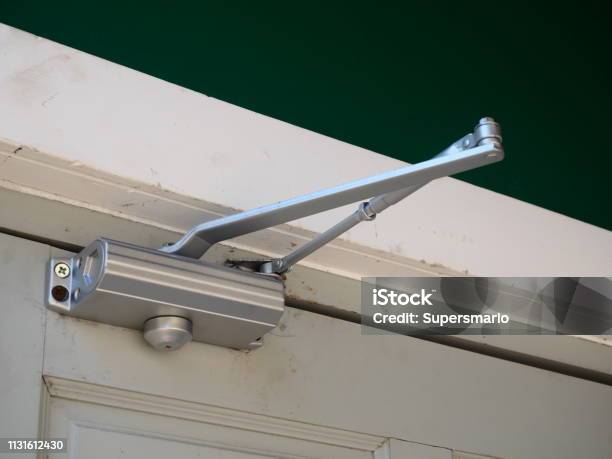 Door Closer Or Shock Absorber Installation Stock Photo - Download Image Now - Door, Approaching, Magnifying Glass