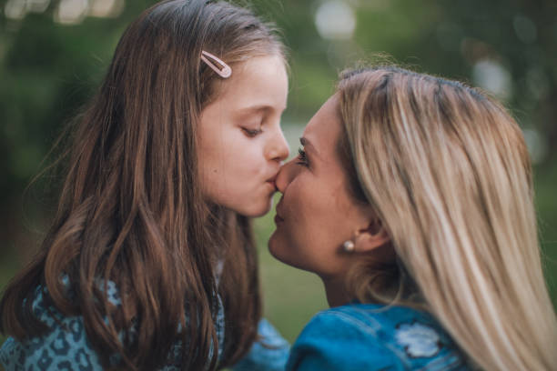 istock Mother and daughter eskimo kissing 1131614249