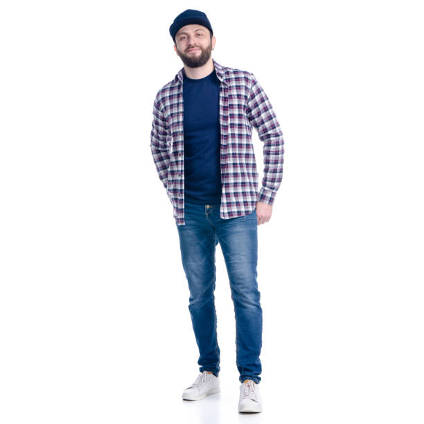 istock Man in jeans, shirt and cap standing smiling 1131617198