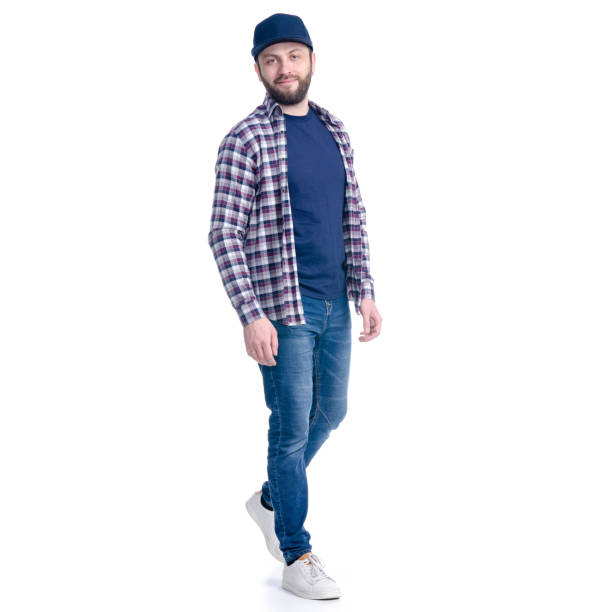 istock Man in jeans, shirt and cap smiling goes walking 1131617204