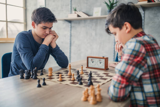 Two boys playing chess Two boys playing chess chess timer stock pictures, royalty-free photos & images