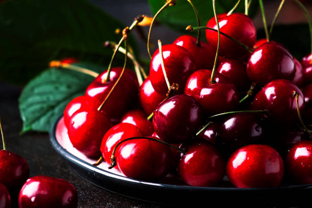 istock Red sweet cherries on brown kitchen table, still life, selective focus 1131620883