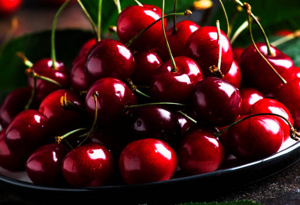 istock Red sweet cherries on brown kitchen table, still life, selective focus 1131620897