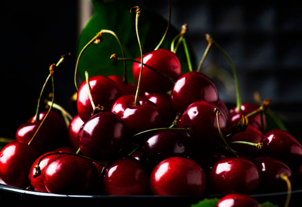 istock Red sweet cherries on brown kitchen table, still life, selective focus 1131620901
