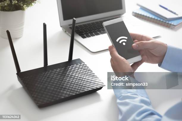 Wireless Router Concept Man Using Smartphone Stock Photo - Download Image Now - Wireless Technology, Office, Radio Wave