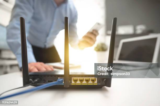 Wireless Router Concept Man Using Smartphone Stock Photo - Download Image Now - Router, Wireless Technology, Internet