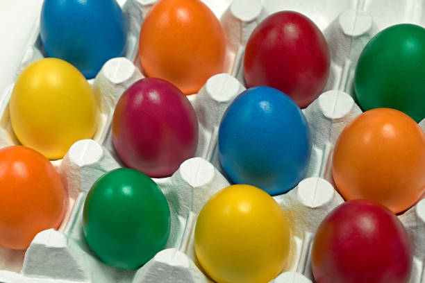 istock Many multicolored Easter eggs in white egg tray Festive tradition Close up Top view 1131624557
