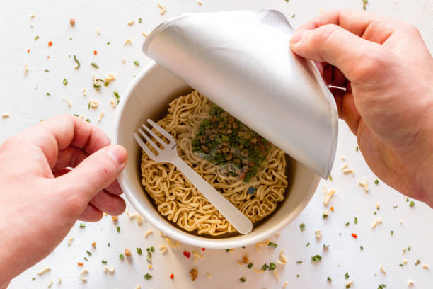 istock man opens the box with instant noodles 1131630431